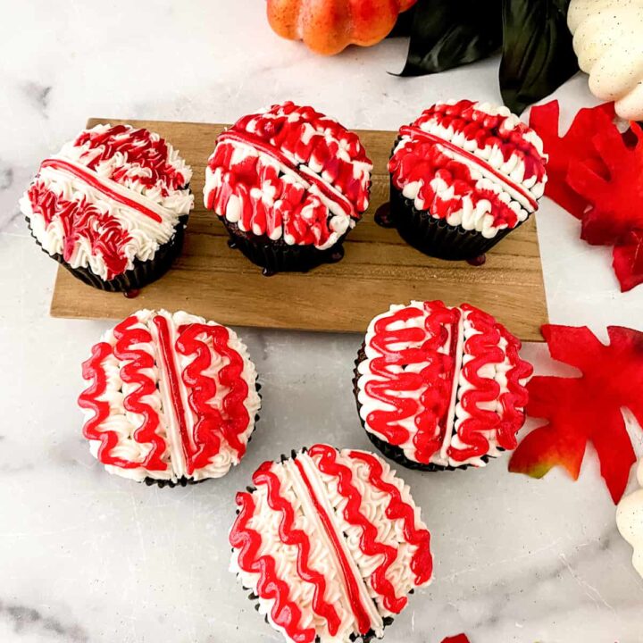 Halloween brain decorated cupcakes on marble table.