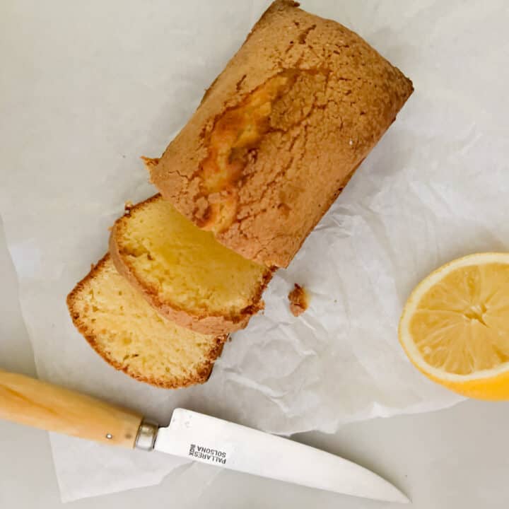 mini pound cake on table with knife and lemon slices.