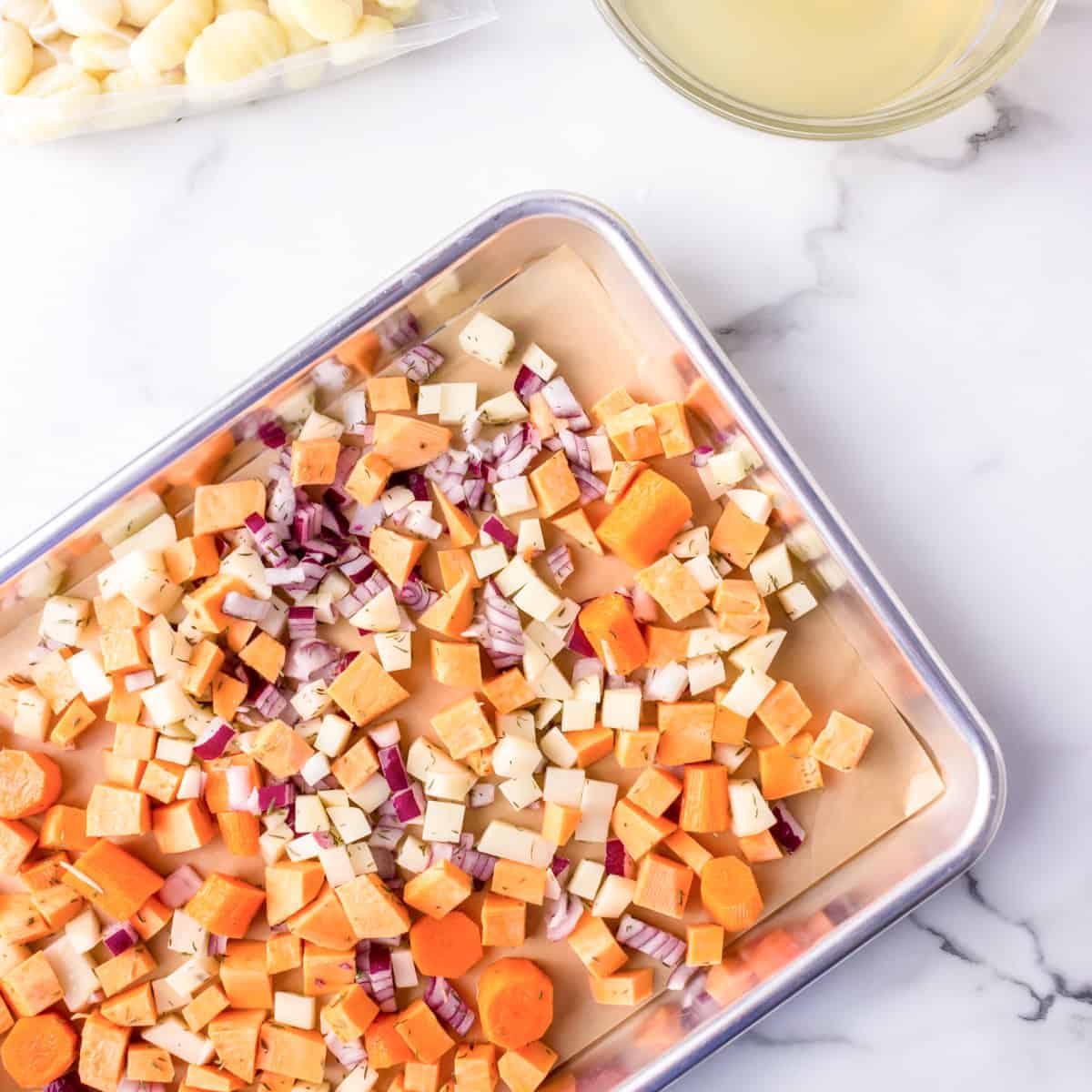 Diced vegetables on a sheet pan.