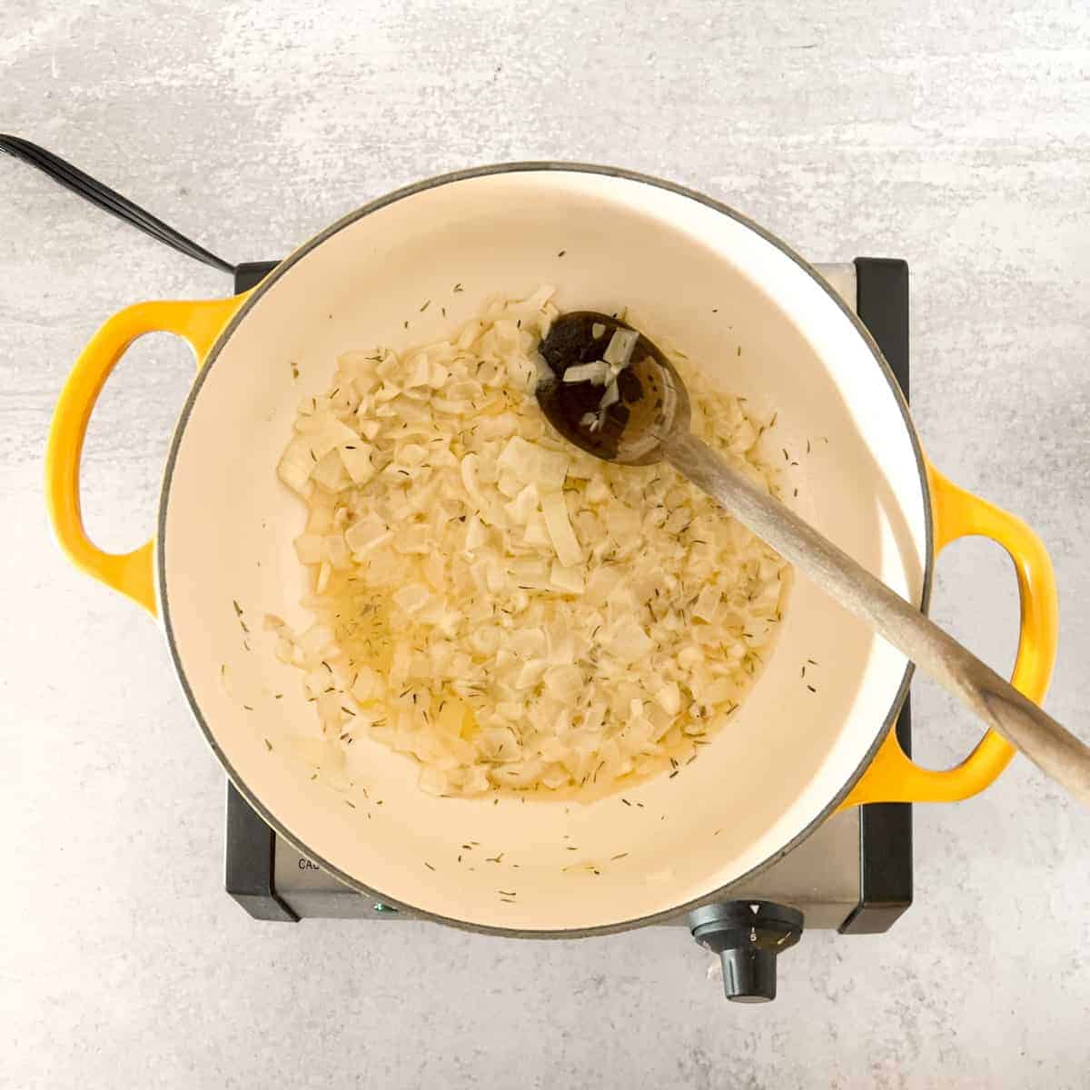 Butter garlic and thyme sauteing in yellow dutch oven.