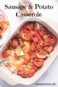 Baked sausage, potatoes and red peppers in casserole dish.