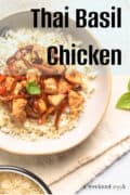 A bowl of thai basil chicken with red peppers served over white rice, text says Thai Basil Chicken.