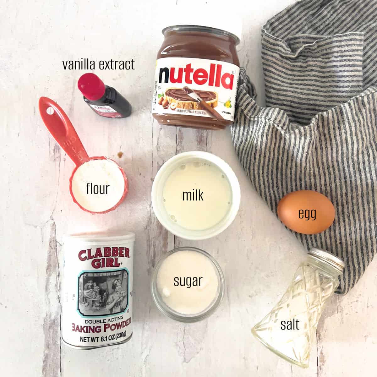 Nutella, vanilla, flour and basic ingredients to make a nutella mug cake.