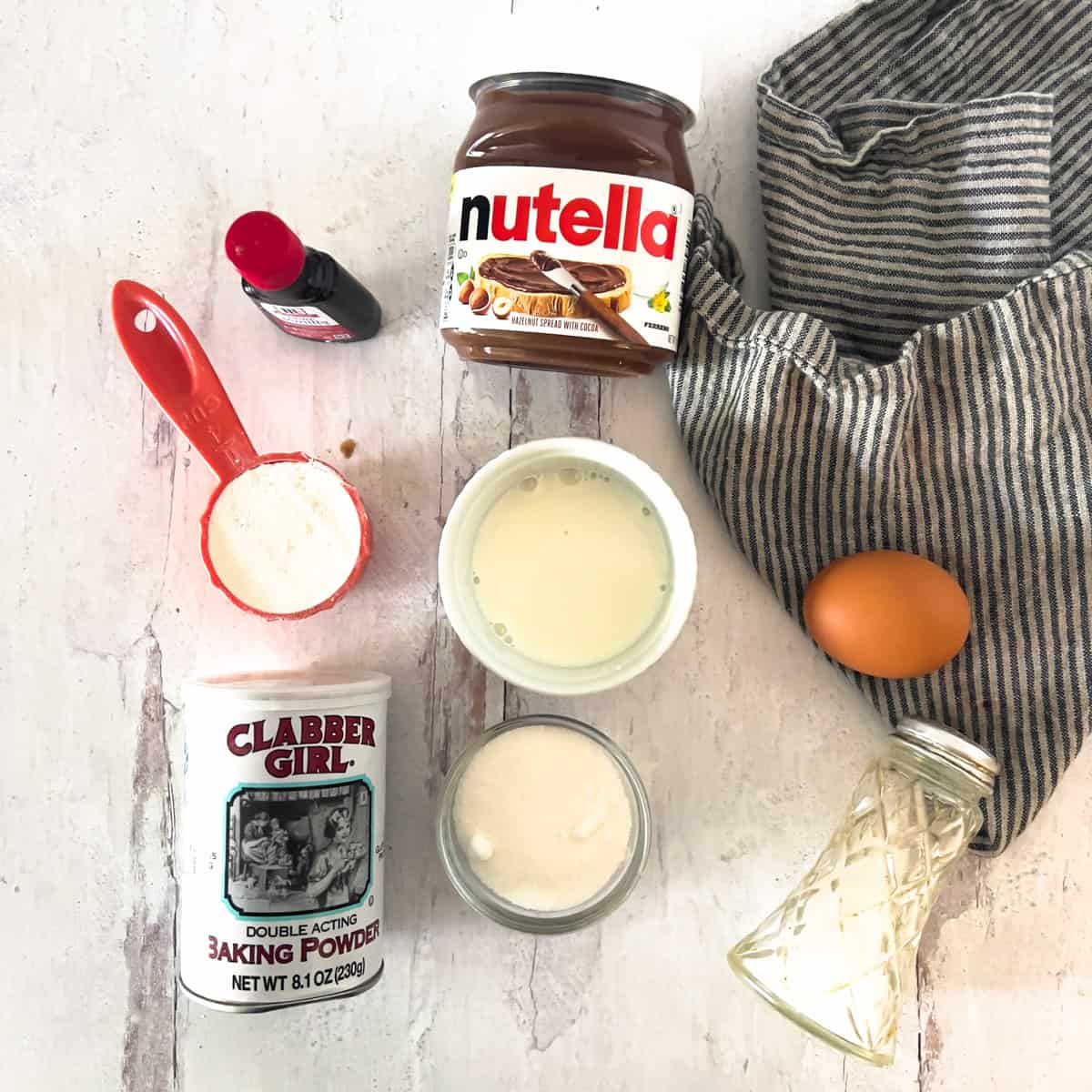 Nutella, vanilla, flour and basic ingredients to make a nutella mug cake.