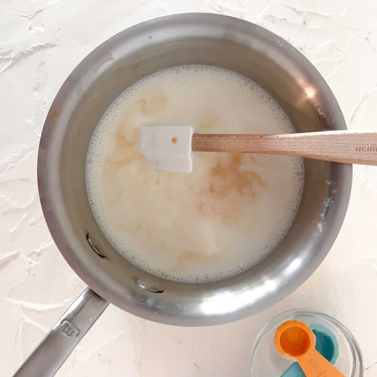 Milk, cream, sugar, and vanilla warming in small saucepan.