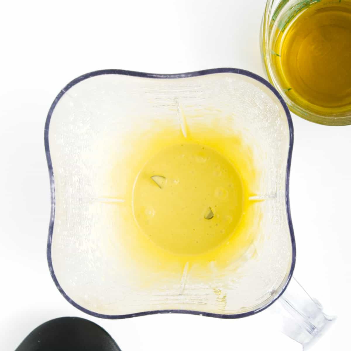 Olive oil, vegetable oil and dijon in blender.