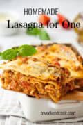 A serving of homemade lasagna for one sits on a white dish, garnished with basil, with another portion in the background. Text reads Homemade Lasagna for One.