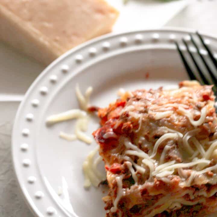 individual lasagna on white plate.