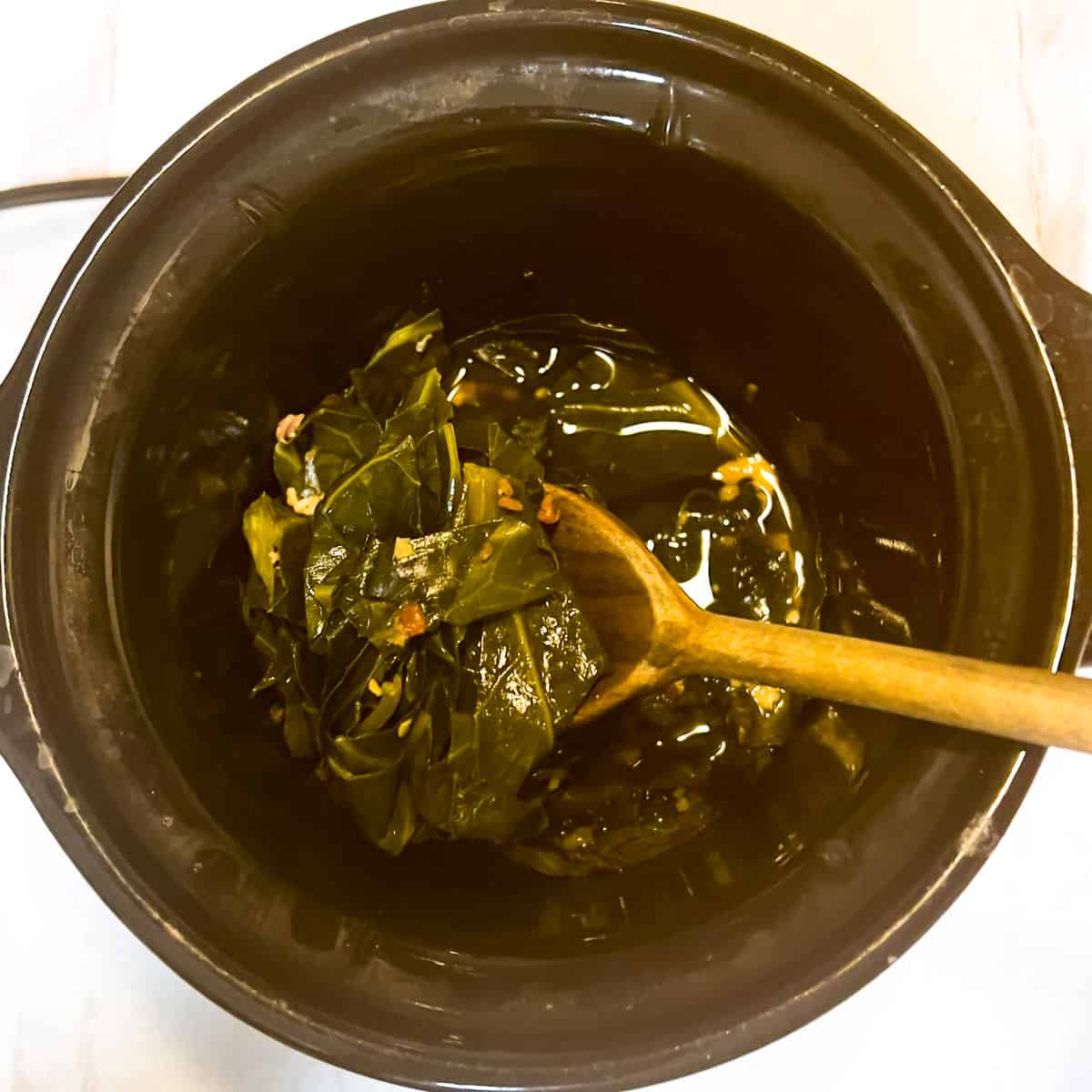 Collard greens cooked in small crockpot.