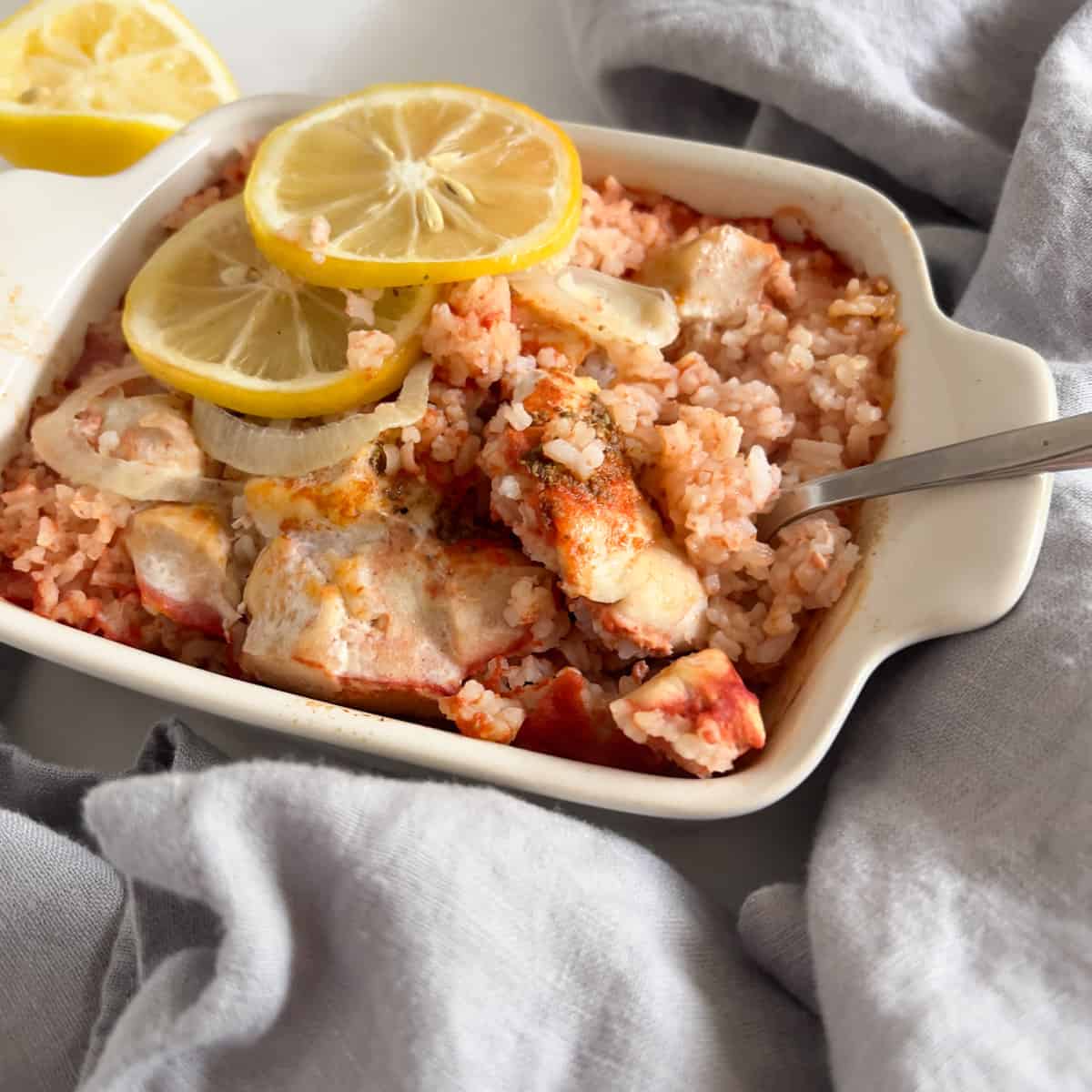 Single serving of lemon chicken and rice casserole dish.