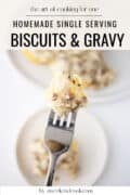 Biscuits and gravy with bite on fork.