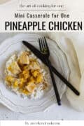 Pineapple chicken over rice on white plate.