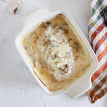 Chicken Raphael casserole in small baking dish next to checkered napkin.