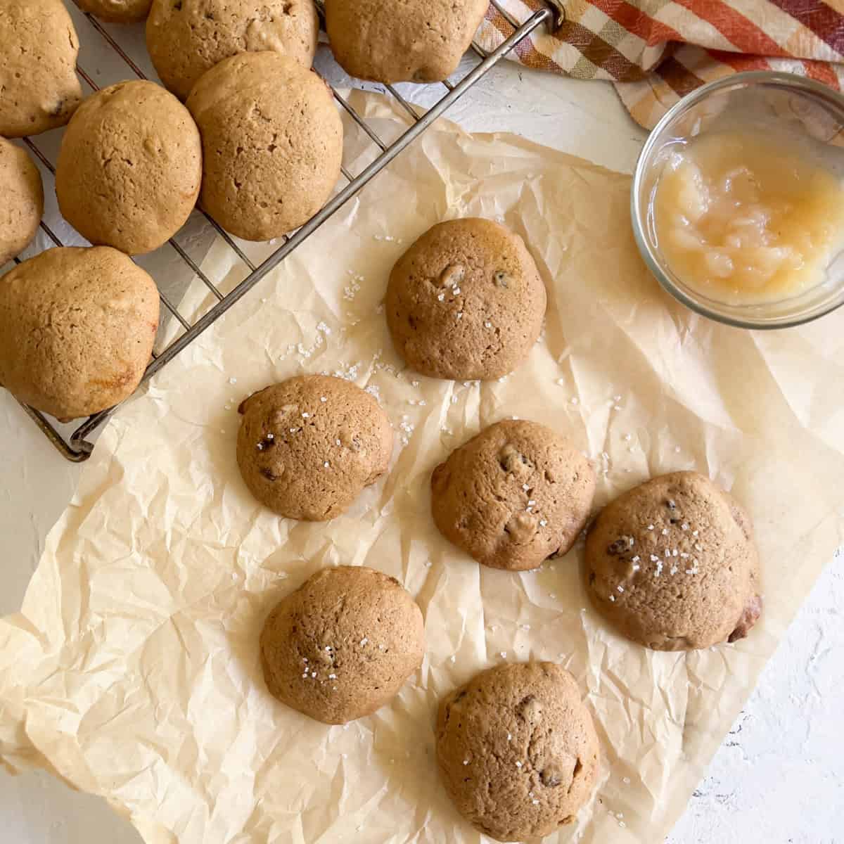 Baked applesauce cookies on parchment paper.