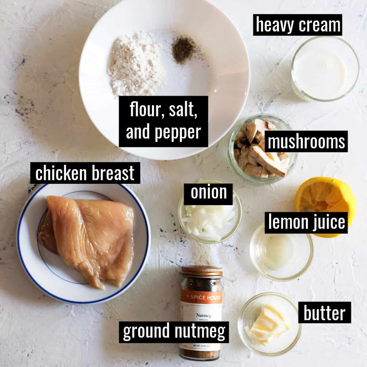 flour, seasonings,butter, onions, mushrooms and chicken breast measure out on countertop.