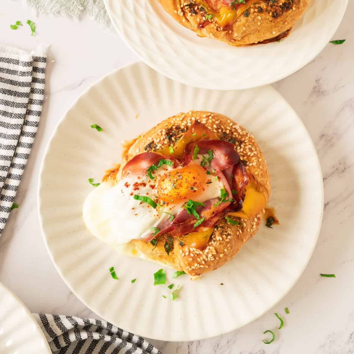 Bagel sandwich with egg, bacon, ham and cheese.