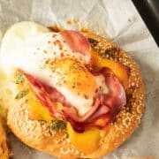 Bagel with melted cheese, egg, bacon and ham.