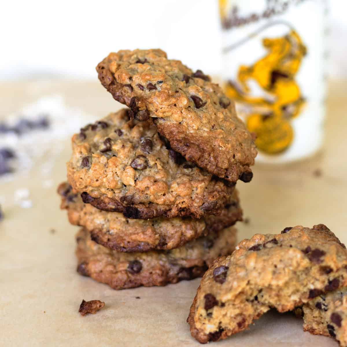 Stack of gowgirl cookies with glass of milk in background.