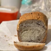 Olive bread with one end slice on paper towel.