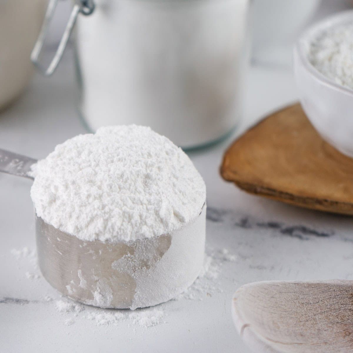 Measuring cup of powdered sugar.