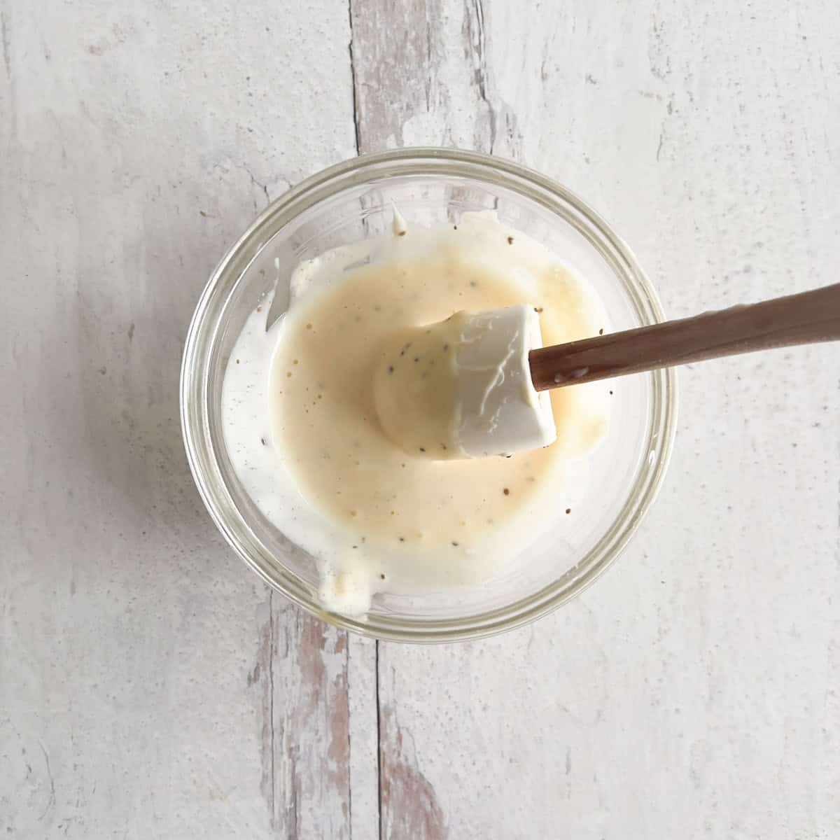 coleslaw dressing in small clear bowl with mini spoonula.