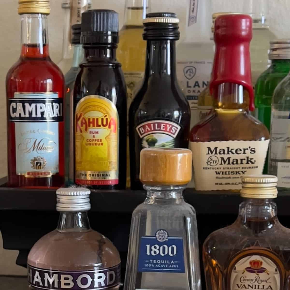 Assorted mini liquor bottles on shelf.