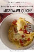 Microwave tomato quiche in bowl with bite on fork.