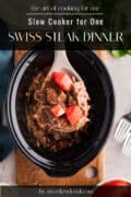 A spoonful of Swiss steak with tomatoes is held above a slow cooker filled with the dish; text overlays promote a slow cooker Swiss steak dinner recipe.