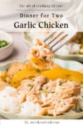 A fork holding a bite of garlic chicken with rice and yellow bell peppers on a plate; text reads Dinner for Two Garlic Chicken.