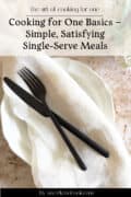 A black knife and fork rest on a beige napkin atop a white plate, with text promoting single-serve meal recipes from aweekendcook.com.
