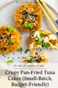 Three crispy pan-fried tuna cakes topped with green onions and sesame seeds are arranged on a plate with chopsticks. One cake has a bite taken out of it. Text overlay promotes the recipe.