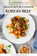 A white plate with rice topped with slow cooker Korean beef, fresh vegetables, and green onions, surrounded by similar dishes and a small bowl of shredded beef. Text reads Small Slow Cooker Korean Beef.