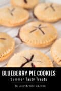 Close-up of freshly baked blueberry pie cookies cooling on a wire rack, with a label reading Blueberry Pie Cookies, Summer Tasty Treats, by aweekendcook.com.