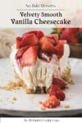 A slice of vanilla cheesecake topped with sliced strawberries sits on a plate with a graham cracker crust and crumbs scattered around.