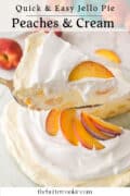 A slice of peach and cream jello pie with whipped topping is lifted from a pie, garnished with fresh peach slices.