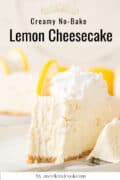 A slice of creamy no-bake lemon cheesecake sits on a white plate, topped with whipped cream, vibrant lemon garnish, and resting on a classic graham cracker crust.
