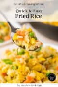 A spoonful of quick and easy fried rice with peas, carrots, and egg.